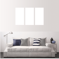 Custom split canvas prints arranged above a stylish sofa in a modern living room setting.