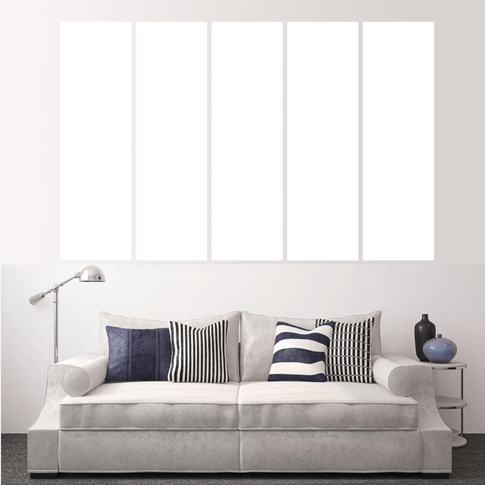 Living room featuring a couch with decorative pillows and an empty wall for custom split canvas prints.
