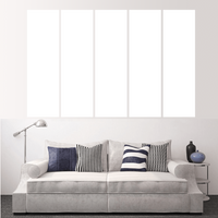 Living room featuring a couch with decorative pillows and an empty wall for custom split canvas prints.