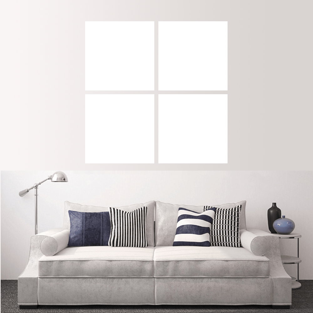 Custom split canvas prints displayed above a modern grey sofa with pillows in a stylish living room.