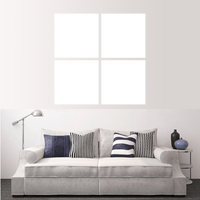 Custom split canvas prints displayed above a modern grey sofa with pillows in a stylish living room.