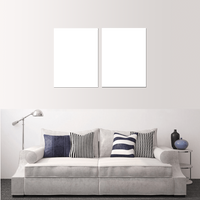 Custom split canvas prints displayed above a modern sofa with decorative pillows.
