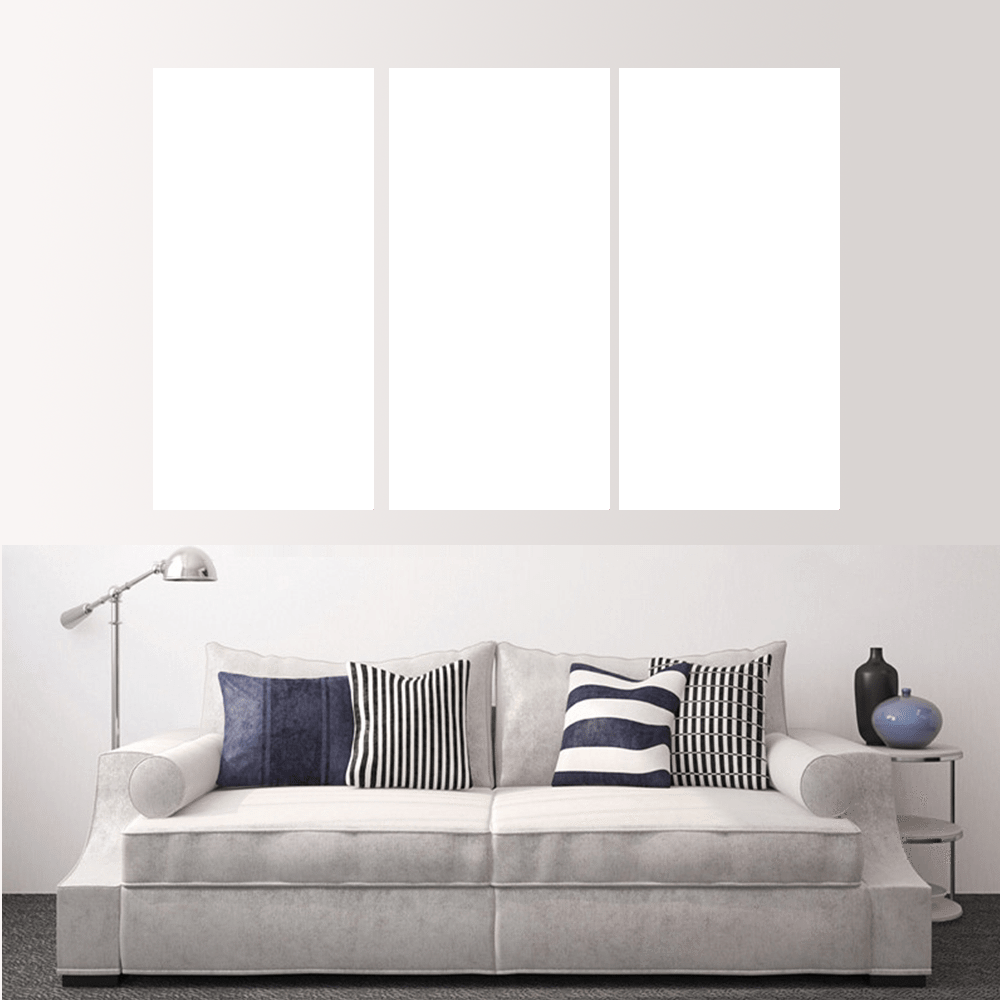 Custom split canvas prints displayed above a modern couch with decorative pillows.