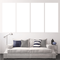 Custom split canvas prints displayed above a stylish sofa with pillows, enhancing modern home decor.