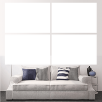 Custom split canvas prints displayed above a stylish couch with patterned pillows in a modern living room.