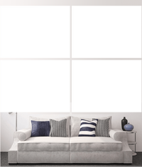 Custom split canvas prints displayed above a stylish couch in a modern living room.