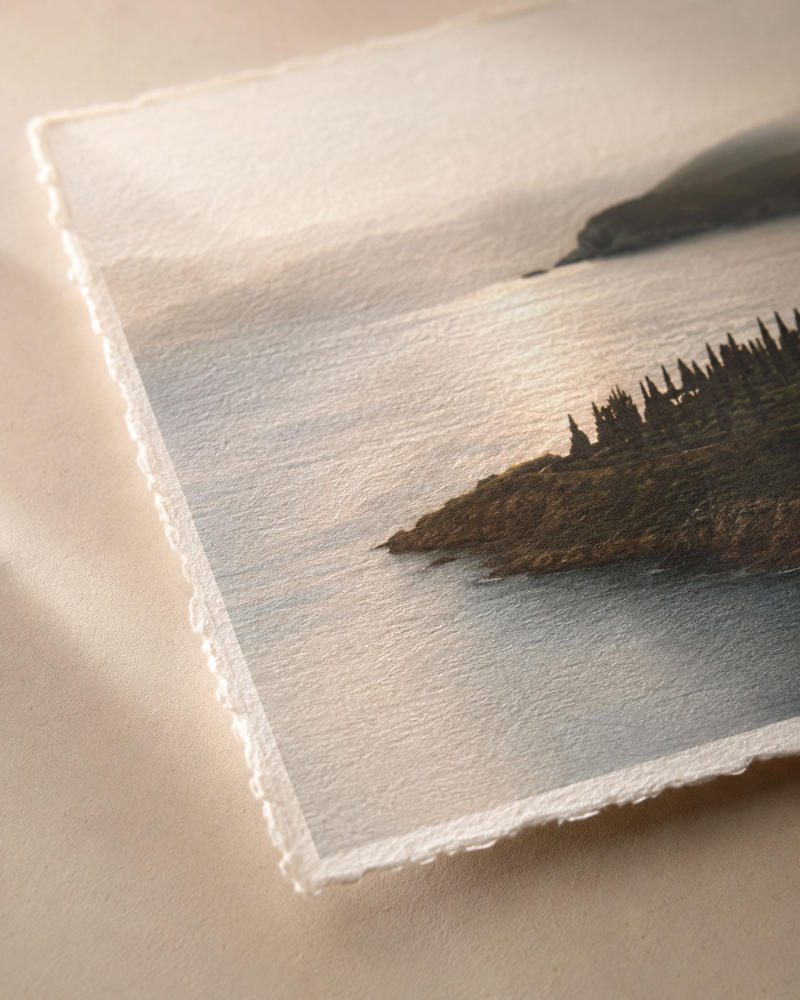 Close-up of a textured fine art paper print showing deckled edges and printed detail.