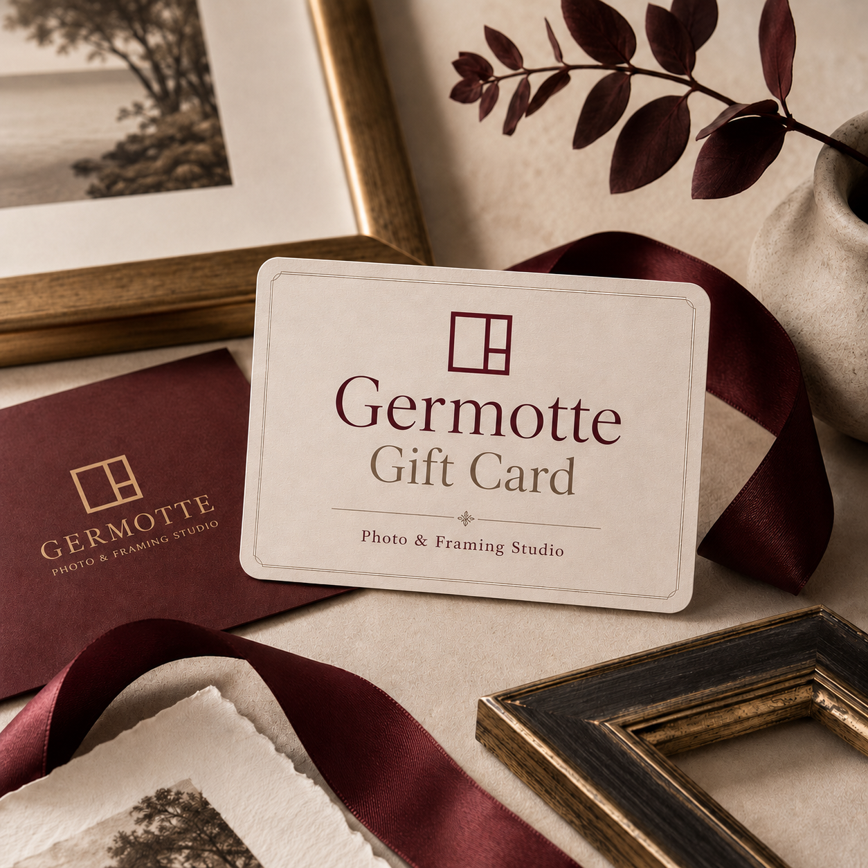 Germotte gift card lifestyle image with burgundy ribbon, framed artwork, and premium photo framing details.