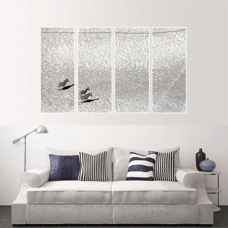 Custom split canvas prints featuring a minimalist design of two birds on textured silver panels above modern sofa.